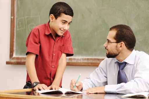 Student and teacher are engaged in a conversation.